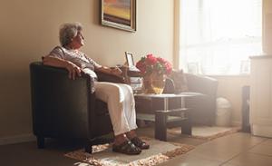 lonely senior woman sitting at home in isolation from COVID-19