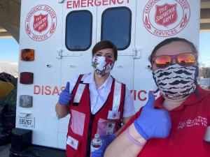 Two thumbs up. We love our new masks. Salvation Army volunteers wearing masks sewn by Scientology Volunteer Ministers