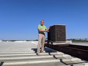 Sr. Project Manager Keith Campbell for McAllen Valley Roofing Co. on top of a commercial metal roof.