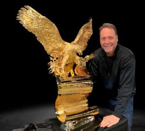 Eagle atop Article 1 of the American Constitution holding an olive branch in its right talons while clutching 13 arrows in its left talon, cast in gold plated bronze for a brilliant shine