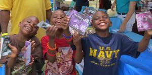 Youth with their DFW booklets at a summer outreach event