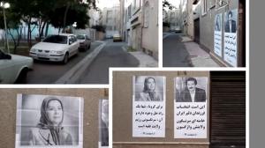 supporters of MEK post banners promoting the resistance leadership's call