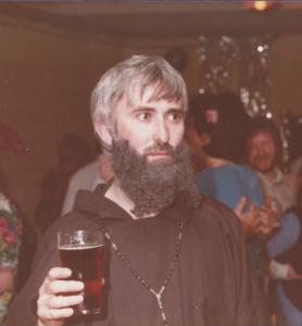 Krunchie Killeen in fancy dress as a friar, holding a pint of stout