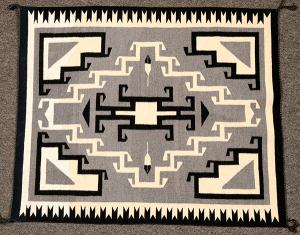 Exquisite Toadlena Two Grey Hills (New Mexico) weaving, 42 inches by 36 inches, in excellent condition, with the four corners hooked, as is the center diamond (est. $1,500-$3,000).