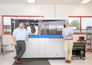 Steve Rengers (left) and Greg Morris of Vertex Manufacturing stand by their Concept Laser M2 DMLM machine.
