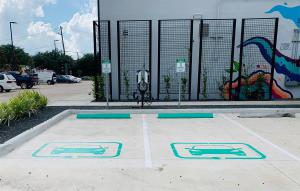 EV charging stations on dual pedestal in the parking lot of 2101 Smith St, Houston