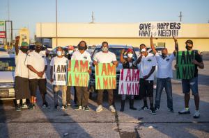 Junior Galette Stands with Group of New Orleans Sanitation Workers Holding I am a Man Signs at Protest for Sanitation Worker Rights