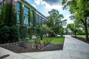 empty college campus with bicycle rack and ivy on the building