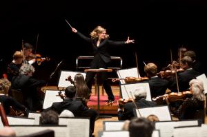 Woman passionately conducting an orchestra