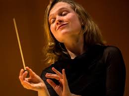 Woman passionately conducting an orchestra