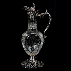 ABCG pedestal ewer, with reticulated sterling silver foot with embossed spout, handle and flip lid by Theodore Starr Co., 14 inches tall, engraved with a fern design, star diamond and fan highlights.