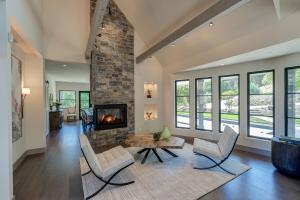 Light-filled sitting room with modern seating and rustic fireplace