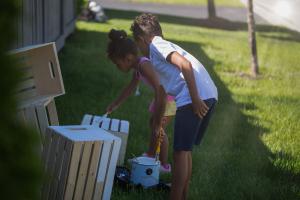 Maxim and Maya painting a box for their stand