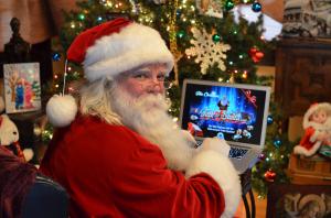 Santa uses his computer to talk to the children of the world