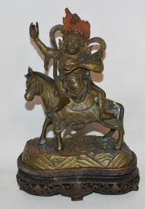 Tibetan bronze Buddha figure on horseback from the 18th or 19th century, 7 ¼ inches tall, with a notarized document from the estate of Ilya Tolstoy.