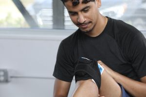 Photo of man using VibraCool Extended unit for knee
