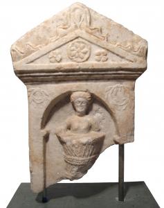 Roman marble funerary stele from the 2nd or 3rd Century AD, 23 ½ inch tall, in the style the man wearing a tunic with wavy hair, his features nicely rendered (est. $4,500-$7,000).
