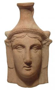 Greek pottery plastic vase depicting a female head, circa 4th C. BC, with youthful features modeled with plump lips and wide eyes, 5 ½ inches tall (est. $3,000-$4,000).