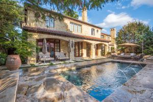 A Turtle Creek resort-style home with pool, cabana, & full bar.