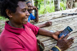 Smallholder Farmer Empowered and Smiling with Mobile Phone