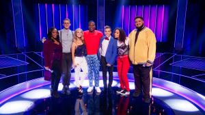 The cast of Episode 7 of Sing On! stand in a row with host Tituss Burgess
