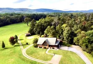custom built log home on 45± acres with a 5,000 sq. ft. shop, pond, creek, and livestock fencing and a desirable Shenandoah Valley location