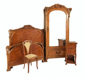 Assembled Art Nouveau bedroom suite attributed to Eugene Vallin, including a bed frame, large armoire, side table and chair, carved with leaves, buds and tendrils ($9,225).
