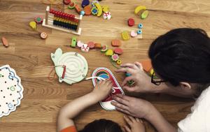 Kizo Kids early childhood educator with toys and child
