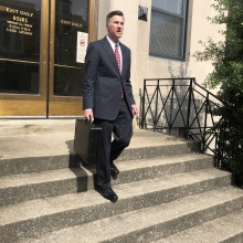 picture of man in suitwalking down stairl