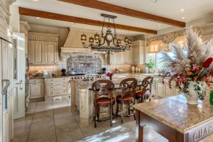 An enormous, spectacular kitchen with limestone fireplace and sitting area can accommodate several chefs at once.