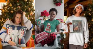a women sits with a snowman pillow in front of a Christmas tree, while another women enjoys a cup of something hot in her retro designed mug and a gentleman stands with a package wearing a long sleeve tshirt with a 1904 Puck Magazine graphic of Santa Clau