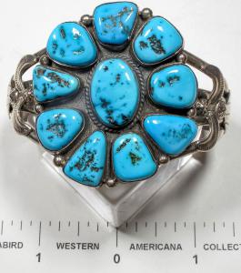 Turquoise cluster bracelet by the well-known Navajo silversmith Ella Peter, boasting beautiful dark blue turquoise stones, flanked on both sides by nice silver work, signed (est. $550-$650).