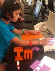 Girl student using web-based FabMaker STEM program to design and fabricate inventions
