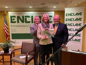 Two men presenting award to a woman, Leslie G. Munger Receives Exemplary Woman Leader 2020 Award from Mayor Craig B. Johnson and Enclave CEO John R. Dallas, Jr.