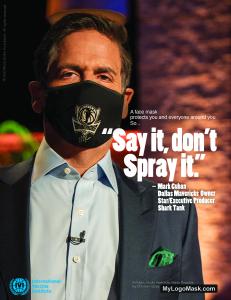 Mark Cuban wears a face mask imprinted with the Dallas Mavericks logo with the headline: "A face mask protects you and everyone around you. Say it, don't spray it."