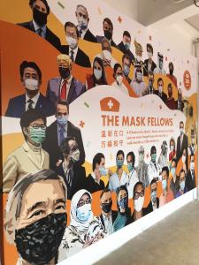 Mask in Unity wall mural featuring world leaders and applauding healthcare workers