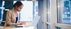 Woman viewing report on her computer