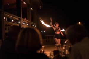 Fire Performer in Front of Restaurant Guests