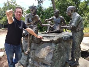 Great US Treasure Hunt president Jeff Kessler finds a hidden coin by Philosophers Rock in Zilker Park, Austin, TX