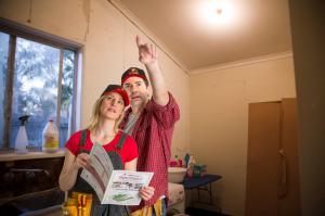 A male and female couple renovating a laundry use the Healthy House Checklist to inspect their laundry which contains asbestos.
