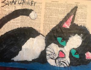 This is an acrylic painting of a cute black and white kitten with big aqua eyes. The painting is on old dictionary pages and then glued to a piece of up-cycled cardboard