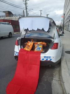 Police car giving out treats and drug education booklets