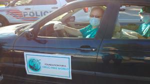 Volunteers at Halloween giving out drug education materials with candy