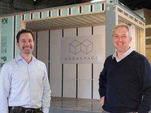  ADDASPACE co-founders Anders Hansen (right) and Andrew Naperotic (left) stand outside of a module that is currently being customized in Bristol, RI.