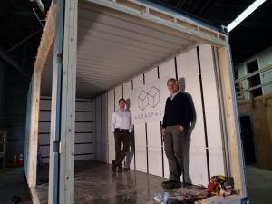 ADDASPACE co-founders Anders Hansen (right) and Andrew Naperotic (left) stand inside a module that is currently being customized in Bristol, RI.