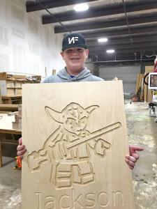 12-year-old Jackson Lucas shows off his rendition of Yoda made in VCarve on the new 5th Generation CNC Factory Python.