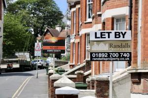 To let signs on a street of red brick houses in the UK