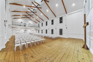 Thoughtfully designed to imbue serenity throughout, the interior spaces feature white and natural wood accents, vaulted ceilings, polished concrete, and oversized windows.