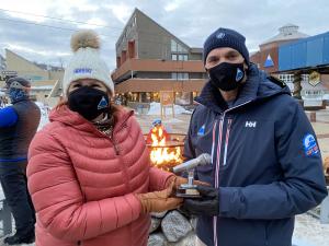 Nancy Marshall, The PR Maven®, presents the Golden Microphone Award to Karl Strand, general manager at Sugarloaf, as the most popular guest on her podcast. Photo courtesy: Marshall Communications