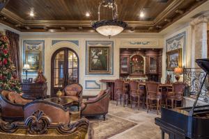 Entertain in its many living spaces, including the great room with full bar and fireplace, kitchen with casual dining area, or formal dining room with wine bar.